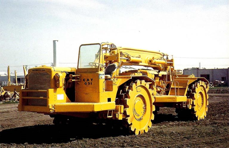 Peterson Twin-631B Tamper compactor with Hyster C400B compacting wheels and two singl-axle Caterpillar 631B scraper tractor